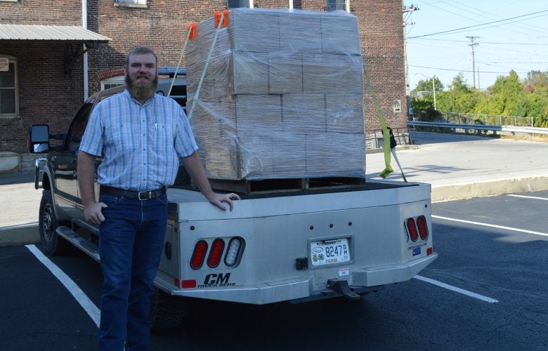 Charlie Crume is shown with donated Castle and Key hand sanitizer.